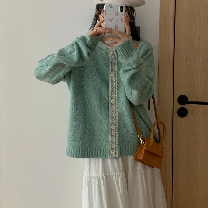 Loose apricot-coloured Korean-style cardigan sweater coat with regular sleeves on a hanger.