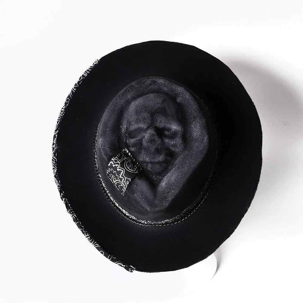 Handmade wool felt denim skull hat with a black conical crown on a white background.