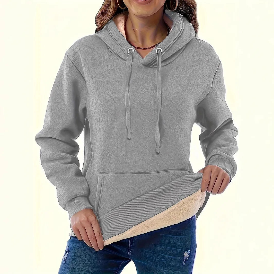 A women's loose fit hooded sweater in thick grey polyester with side pockets and long sleeves.