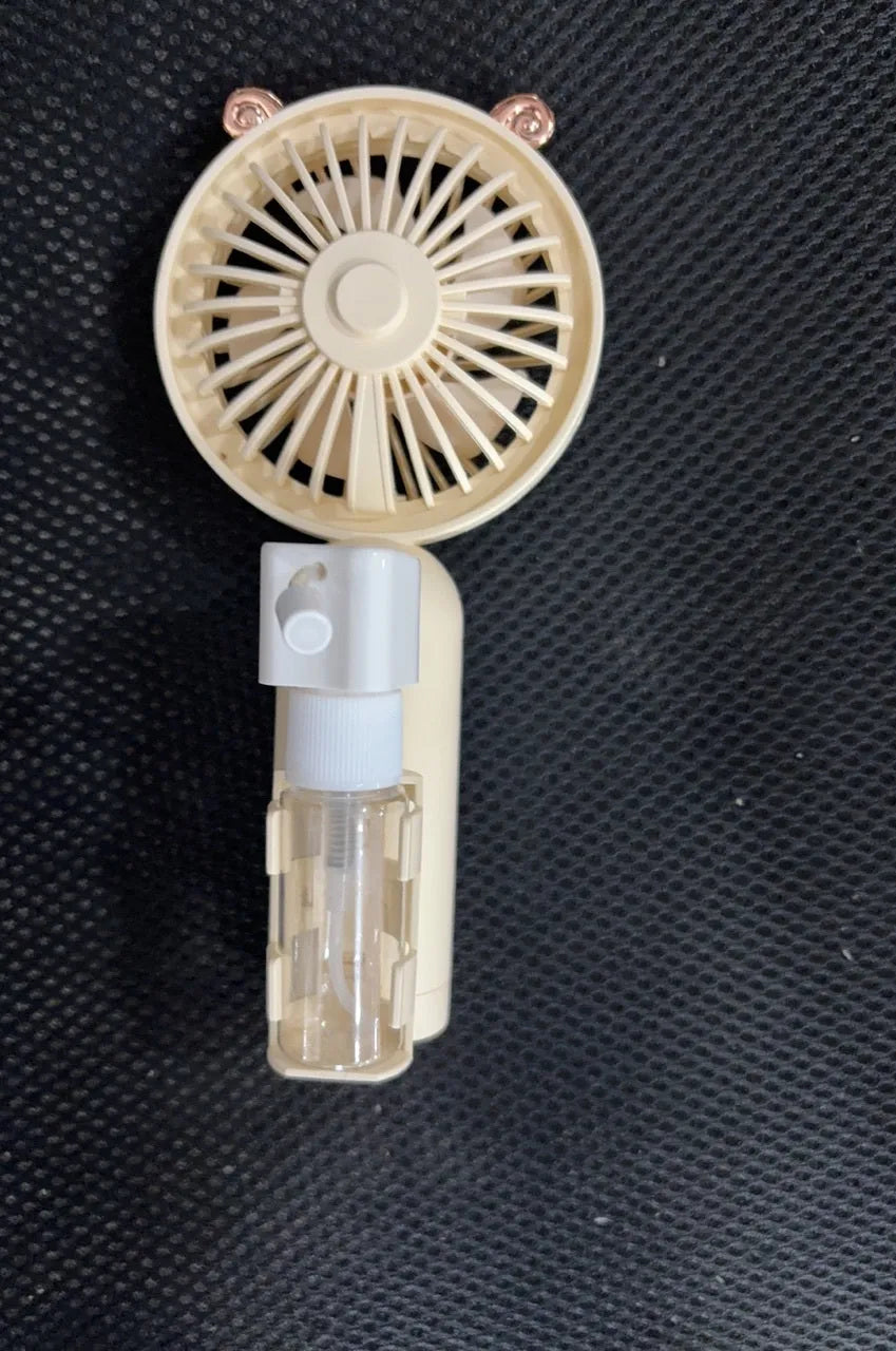 Personalised plastic handheld desk fan with USB port in apricot colour, showing scale.