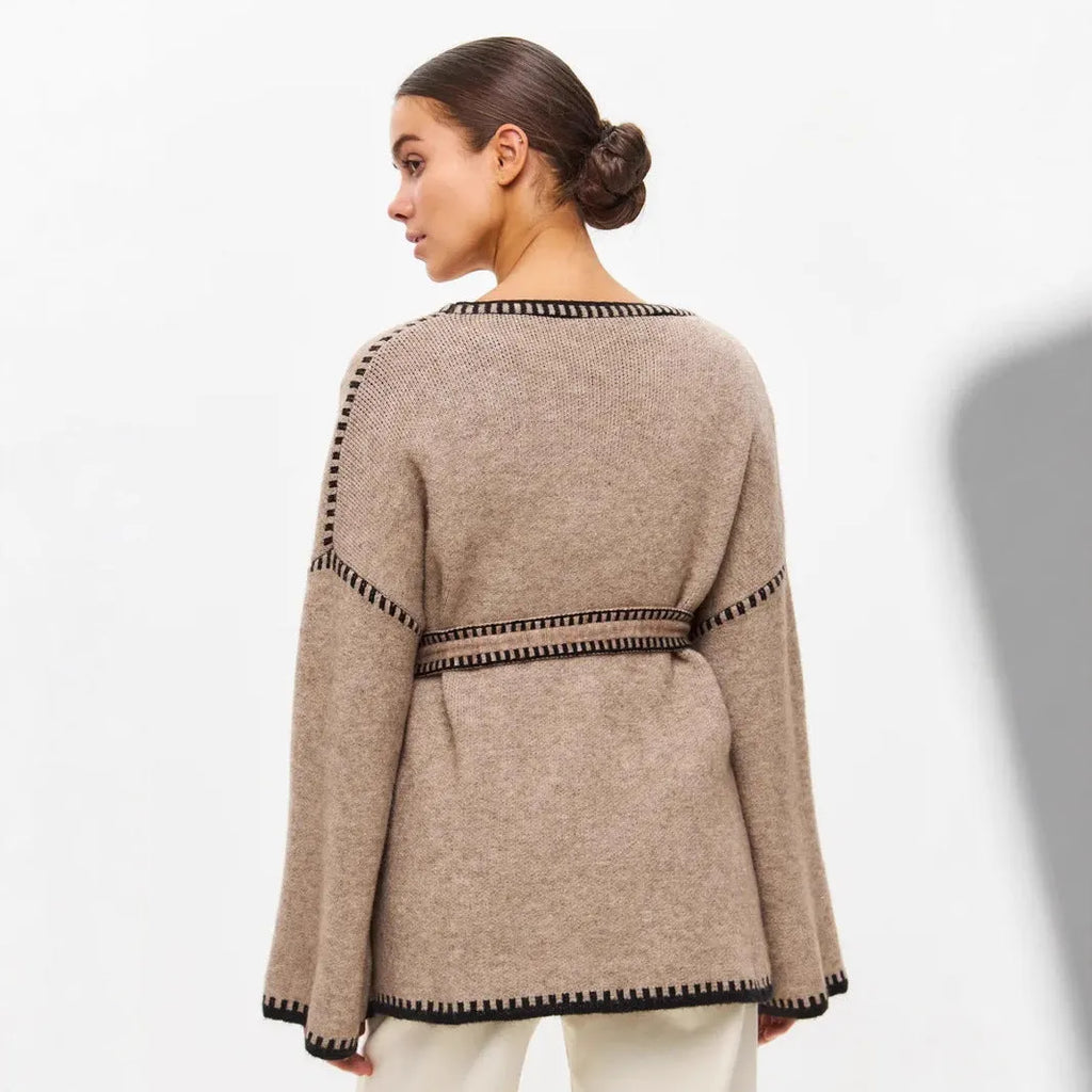 Lace-up front knitted cardigan sweater coat in camel colour, showing loose fit and long sleeves.