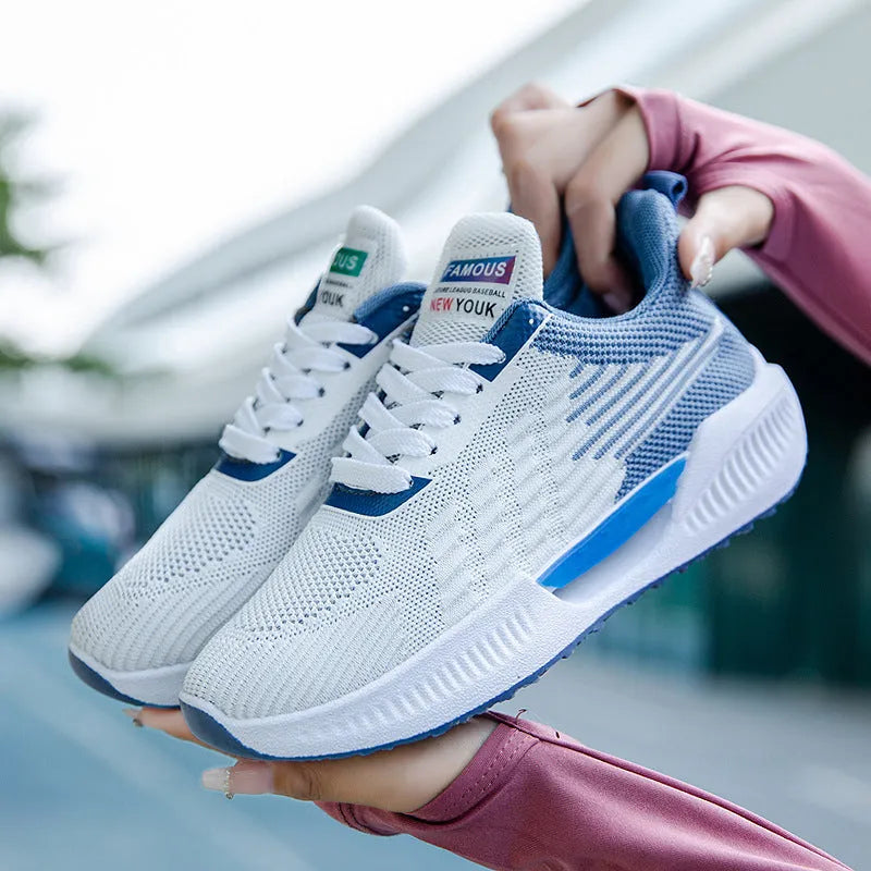 Men's blue mesh sports shoes with round toe and plastic sole on a grey background.