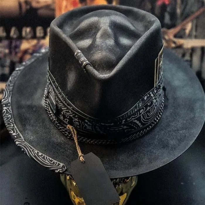 Handmade wool felt denim skull hat with a black conical crown on a white background.