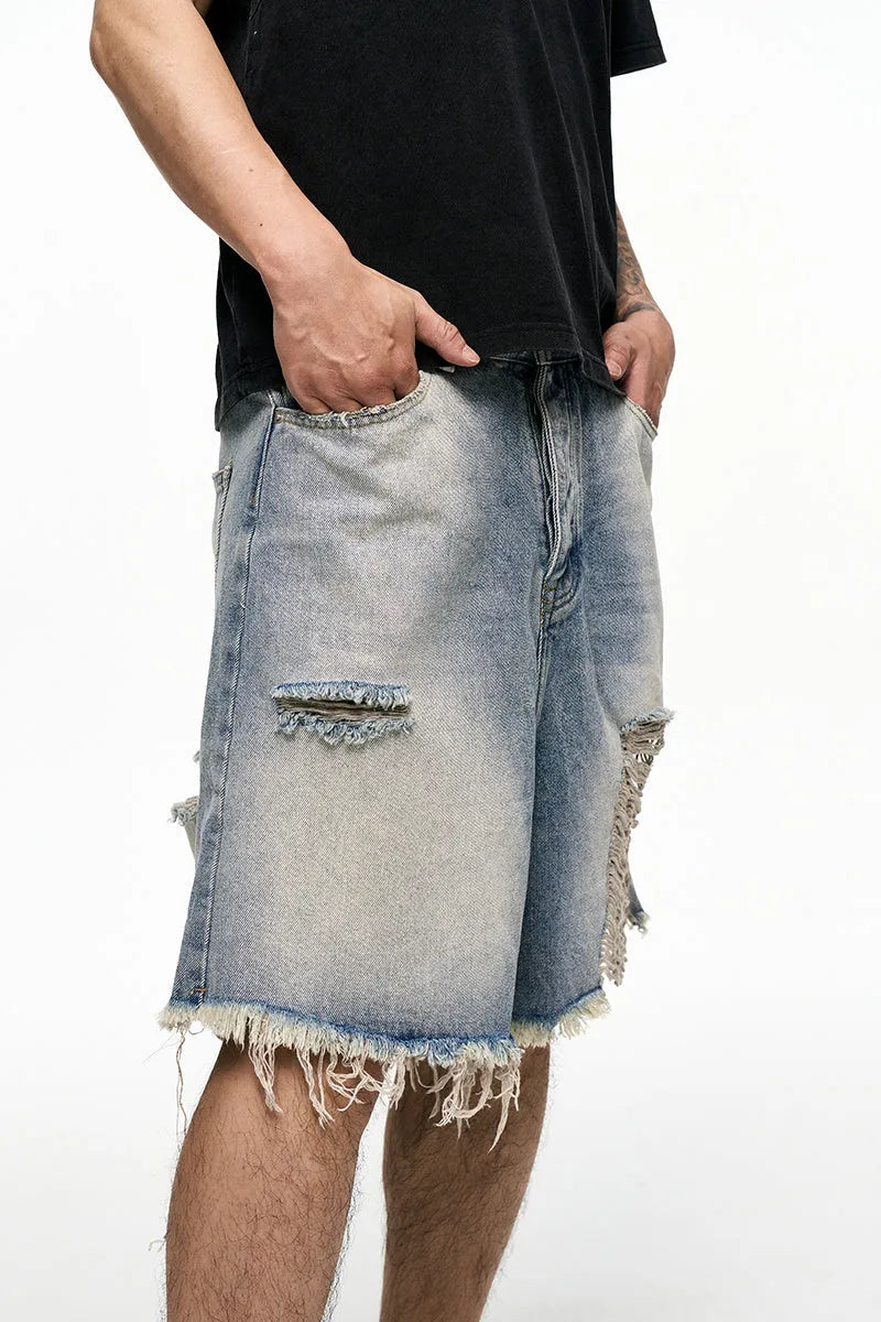 Light blue men's baggy denim shorts with wide leg and mid waist on a plain background