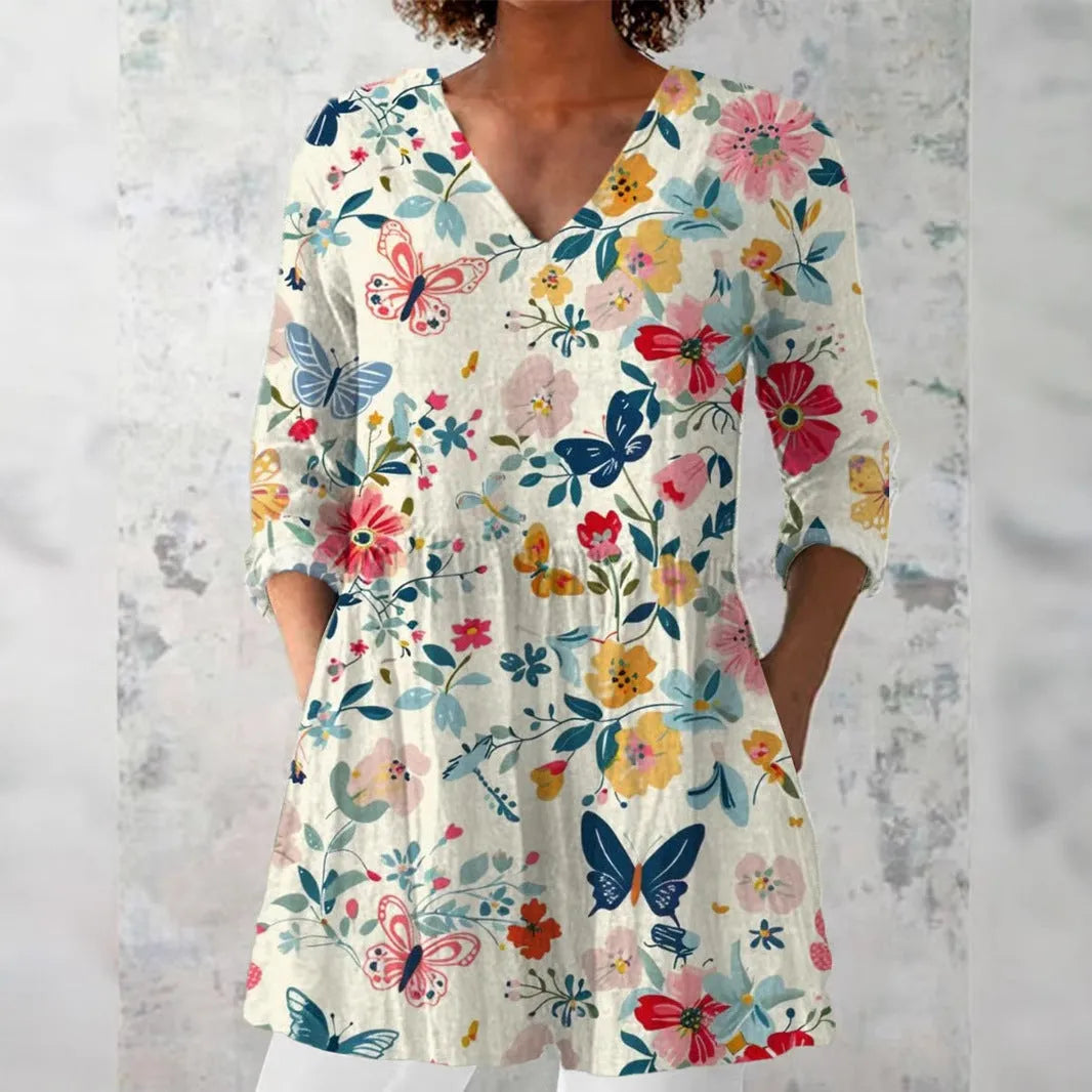 Women's slim-fit retro printed long-sleeved polyester top on a hanger, showing detail of digital print.