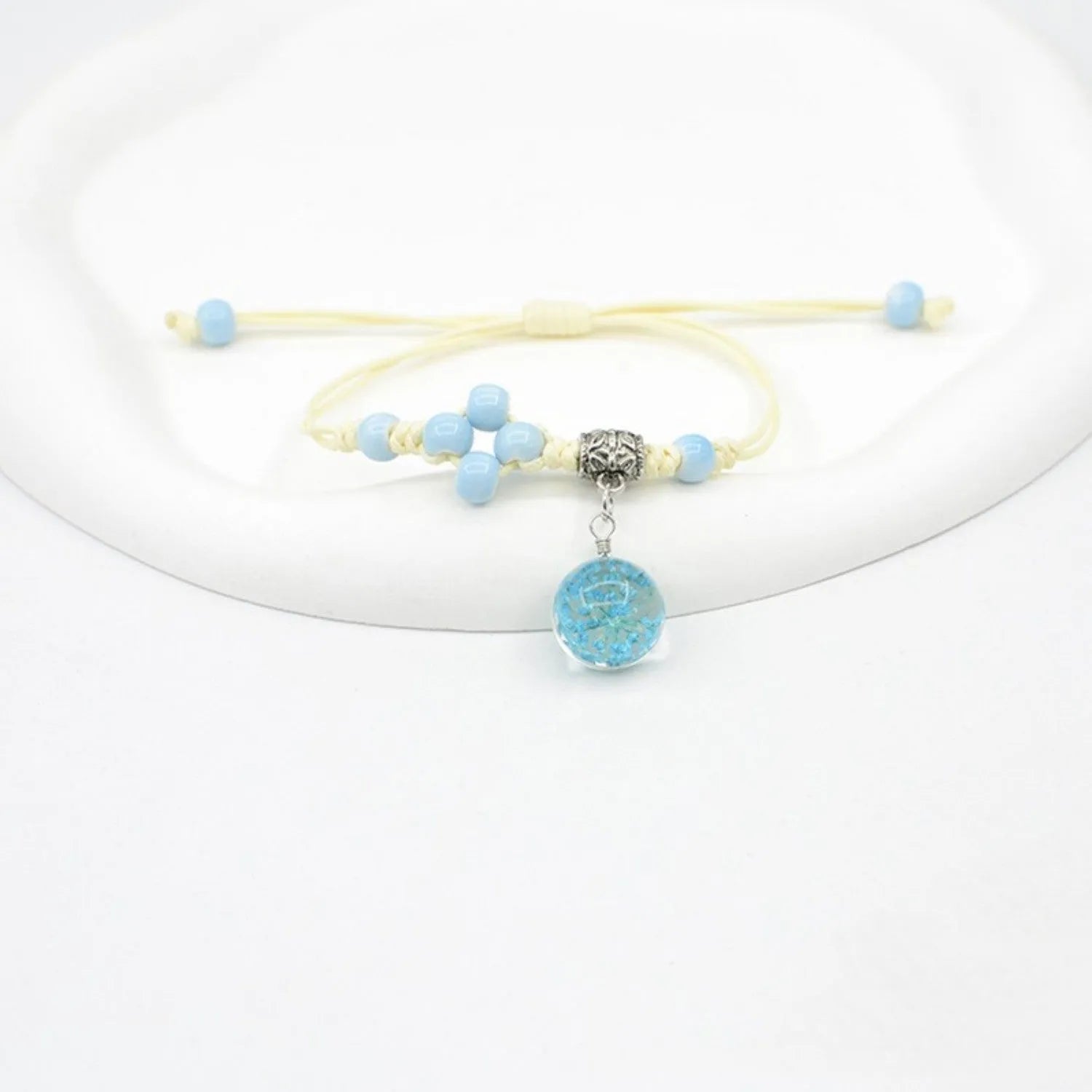 Glass dried flower bracelet with large 1.4 cm beads containing real preserved flowers in hand-woven lace design
