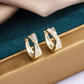 14K yellow geometric copper earrings with zircon accent on white background