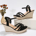Women's wedge sandals with fish mouth toe design in black cloth material showing wedge heel