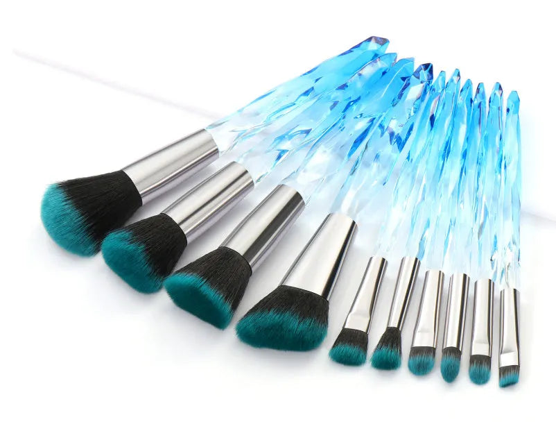 Set of 10 crystal-handled foundation brushes with synthetic bristles laid out flat.