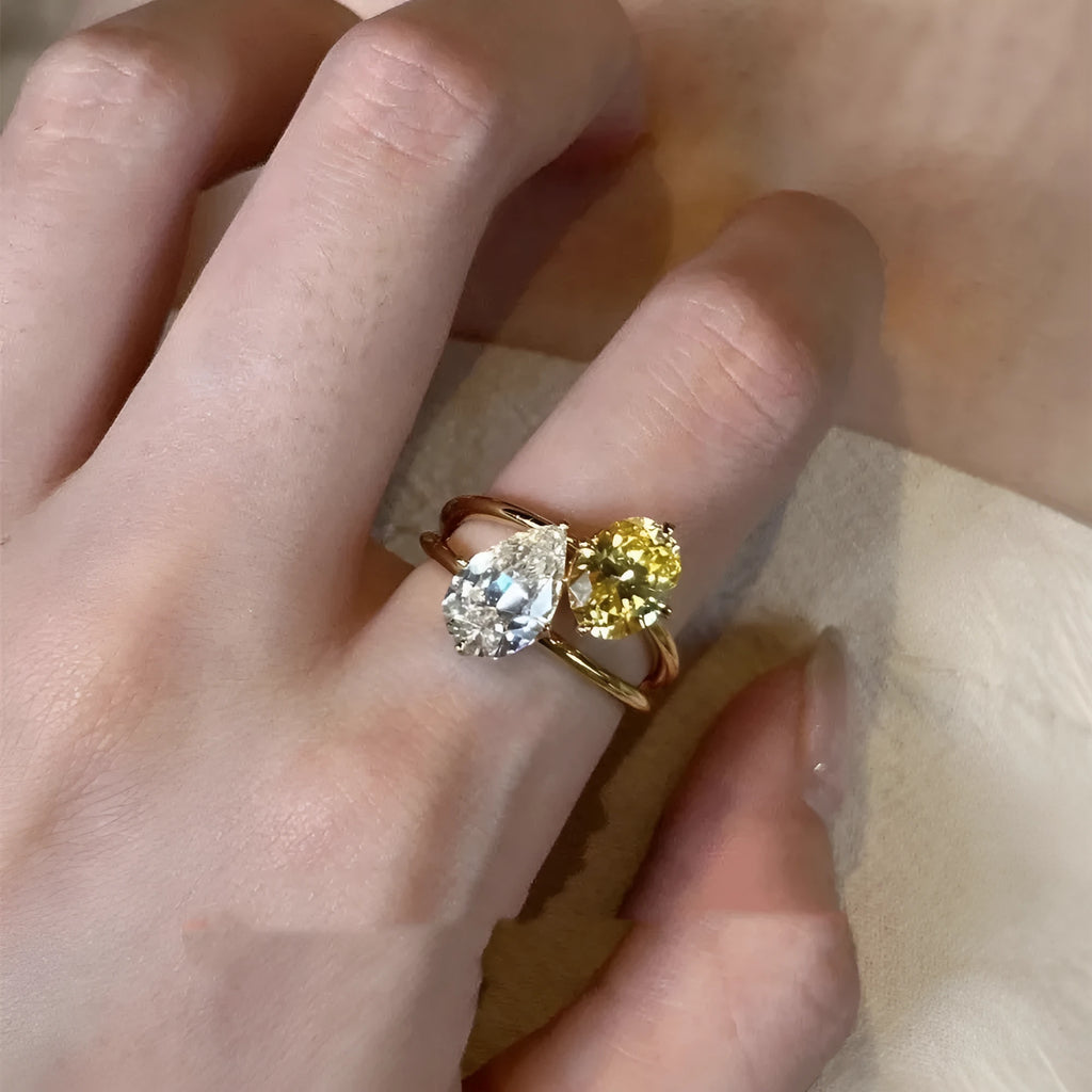 Geometric open copper ring for women with a central water drop double Sheng zircon stone.