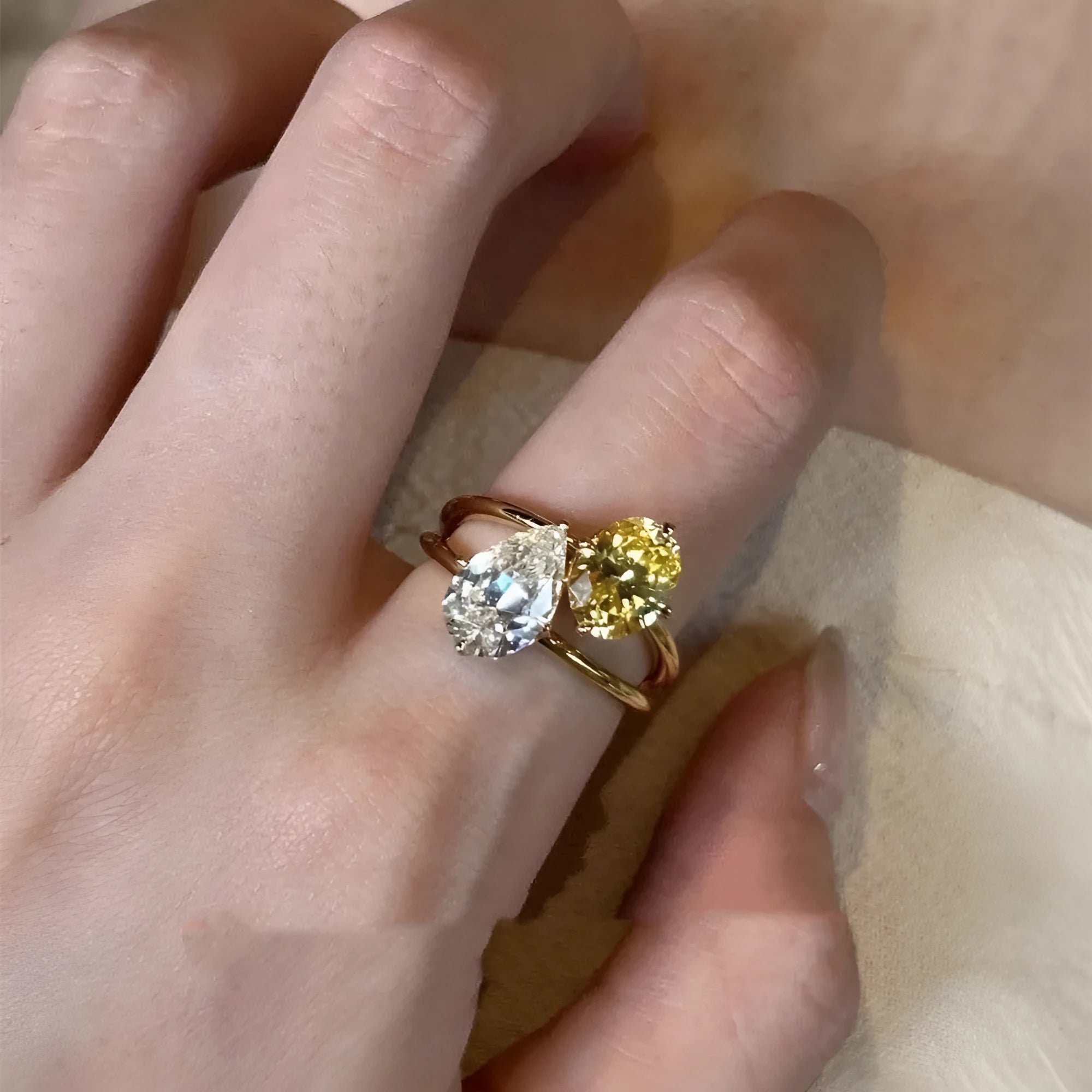 Geometric open copper ring for women with a central water drop double Sheng zircon stone.