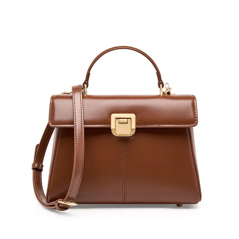 Women's black genuine leather shoulder bag with gold clasp closure showing interior compartments