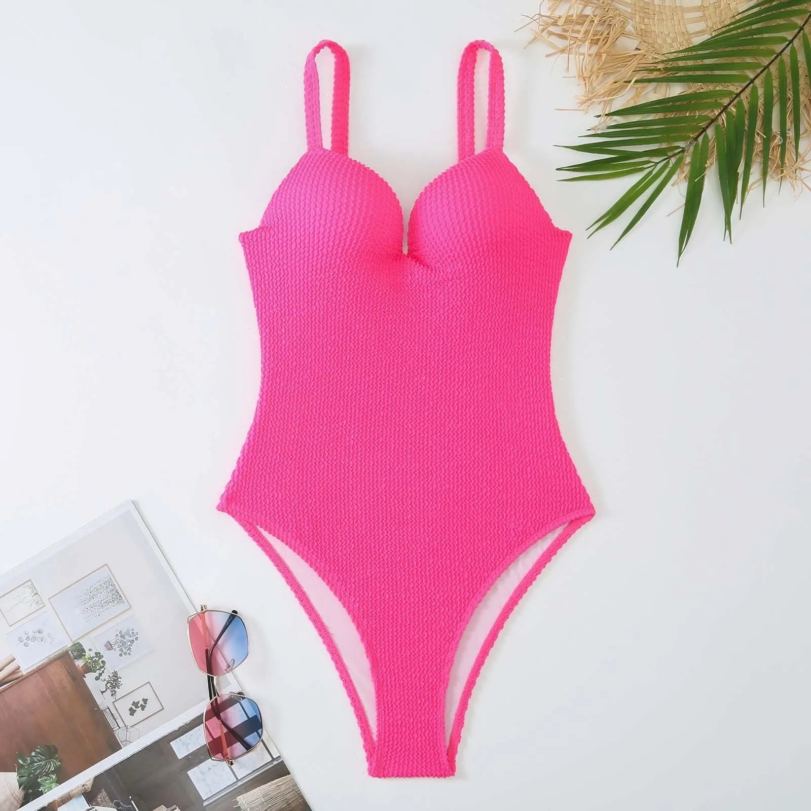 Women's black and striped one-piece sleeveless swimsuit laid flat.
