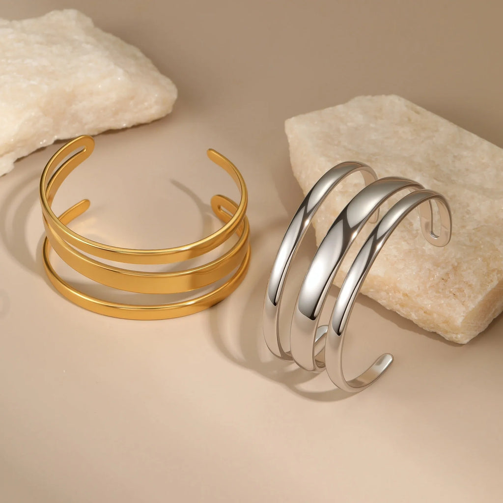 Geometric line design stainless steel women's bracelet with a simple opening clasp, shown in gold and steel colour options.