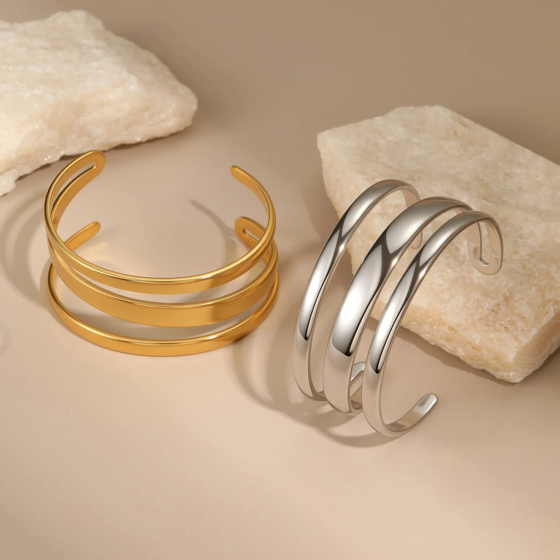 Geometric line design stainless steel women's bracelet with a simple opening clasp, shown in gold and steel colour options.