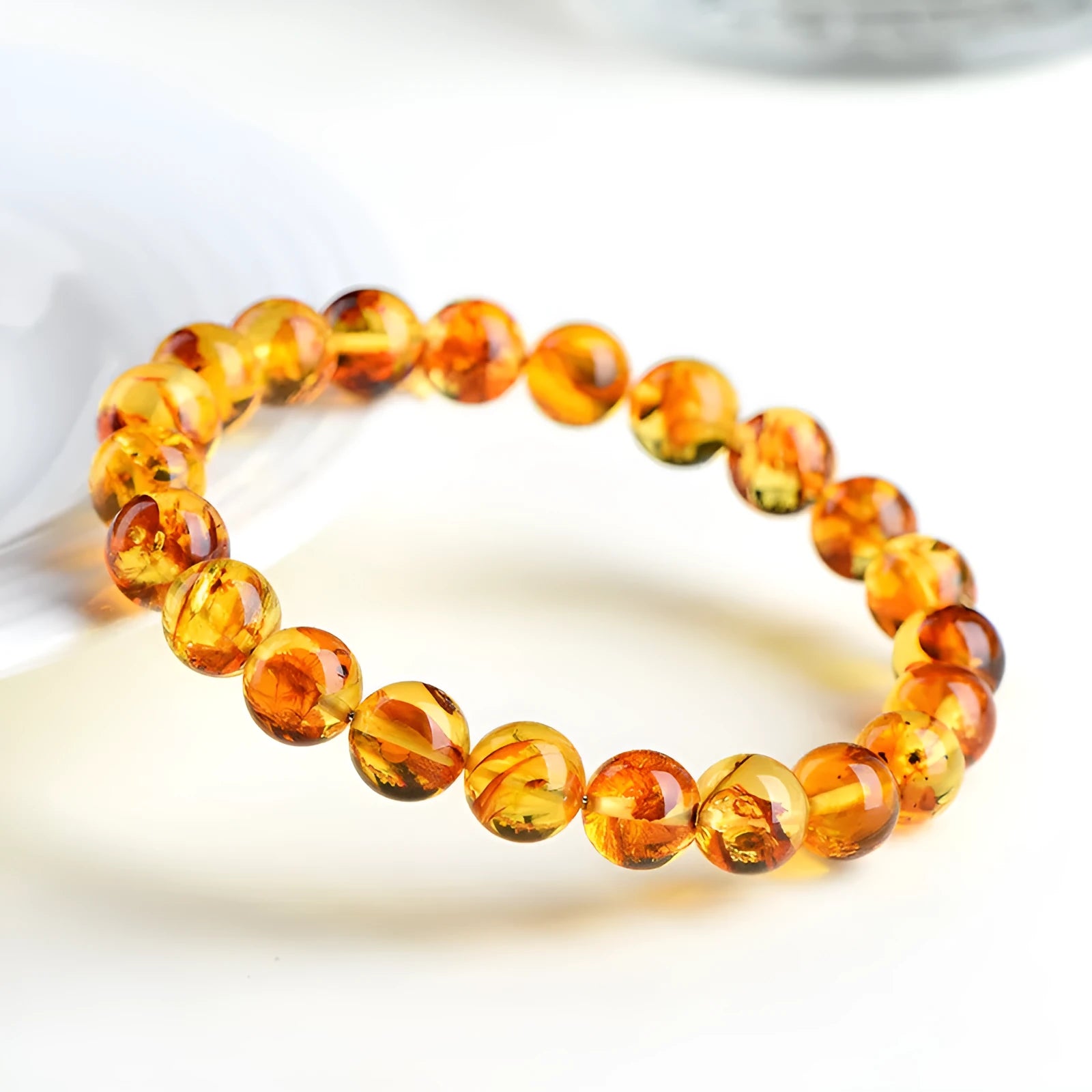 Natural yellow piebald amber bracelet with geometric polished beads showing flower spot patterning