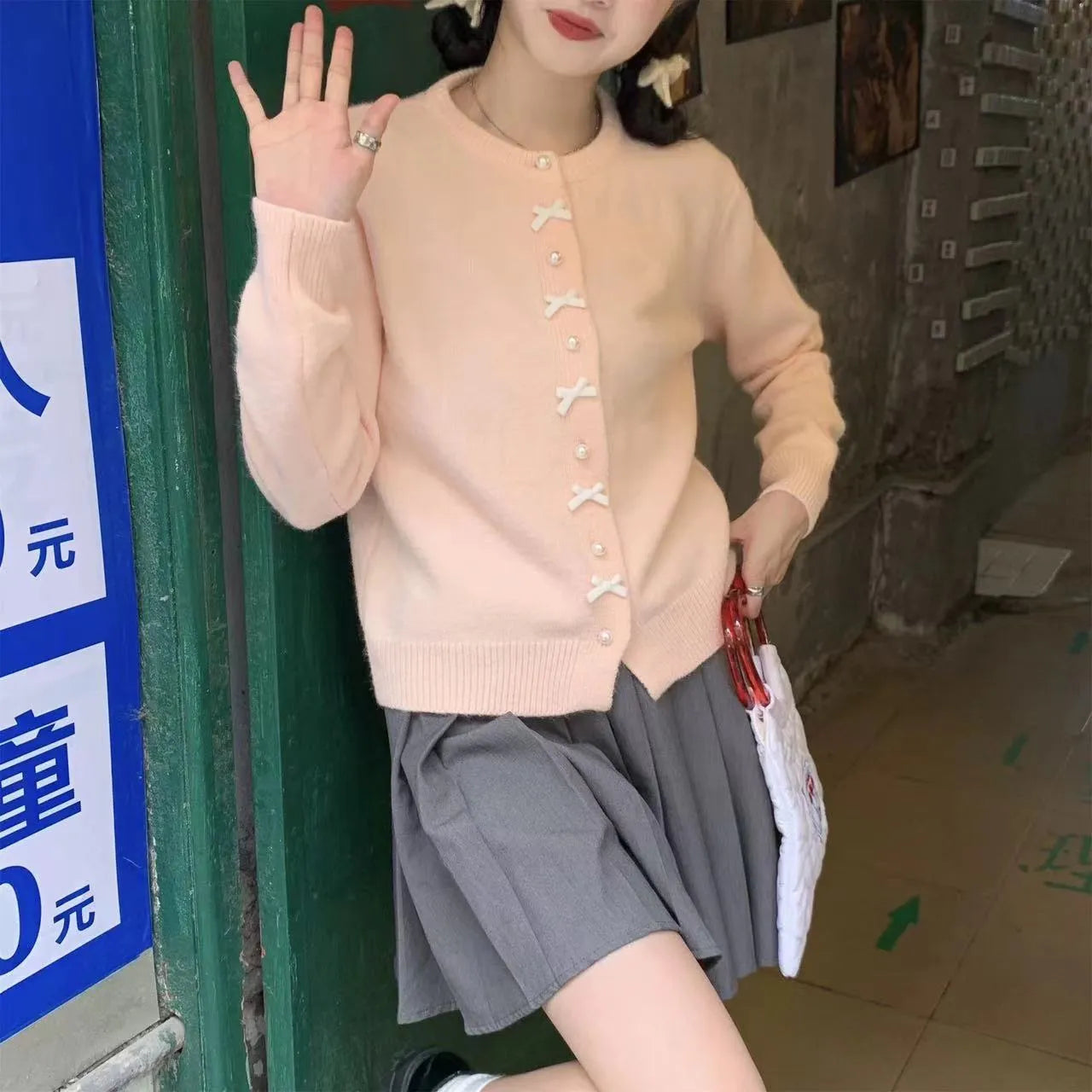 Women's acrylic cashmere cardigan sweater with bow and pearl button detail in nine colour options