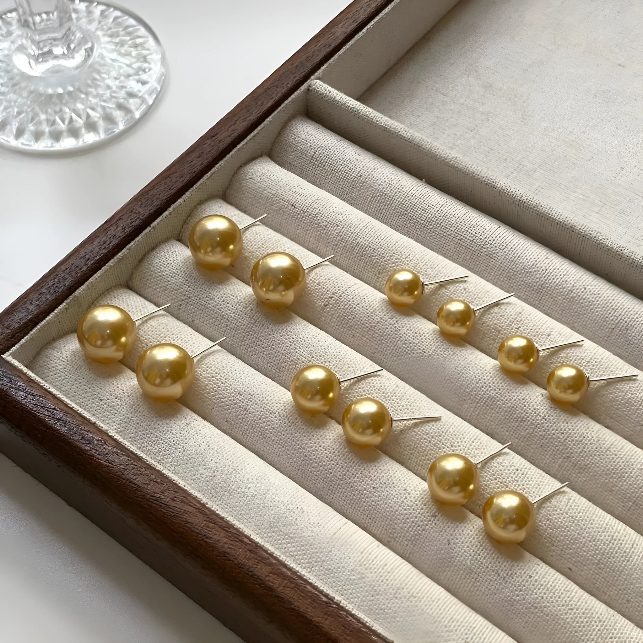 Women's large pearl stud earrings with an eight-pointed star geometric setting in sterling silver.