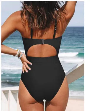 Women's black cross-back one-piece swimsuit with backless design and solid colour pattern