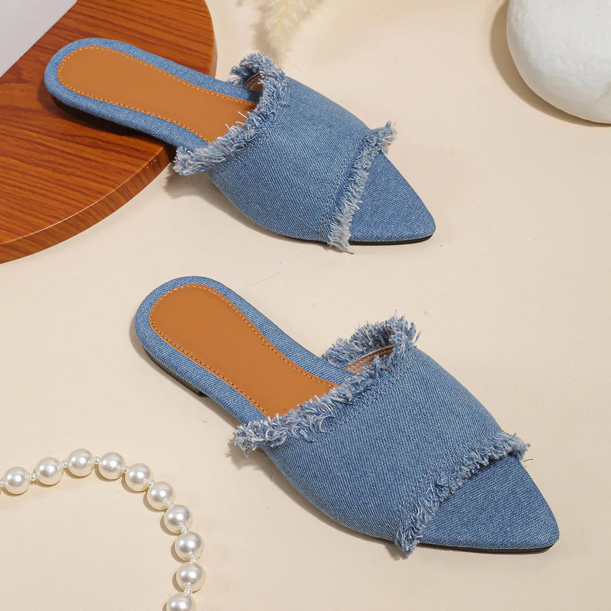 Women's denim casual flat slippers with a tassel detail in multiple colour options.