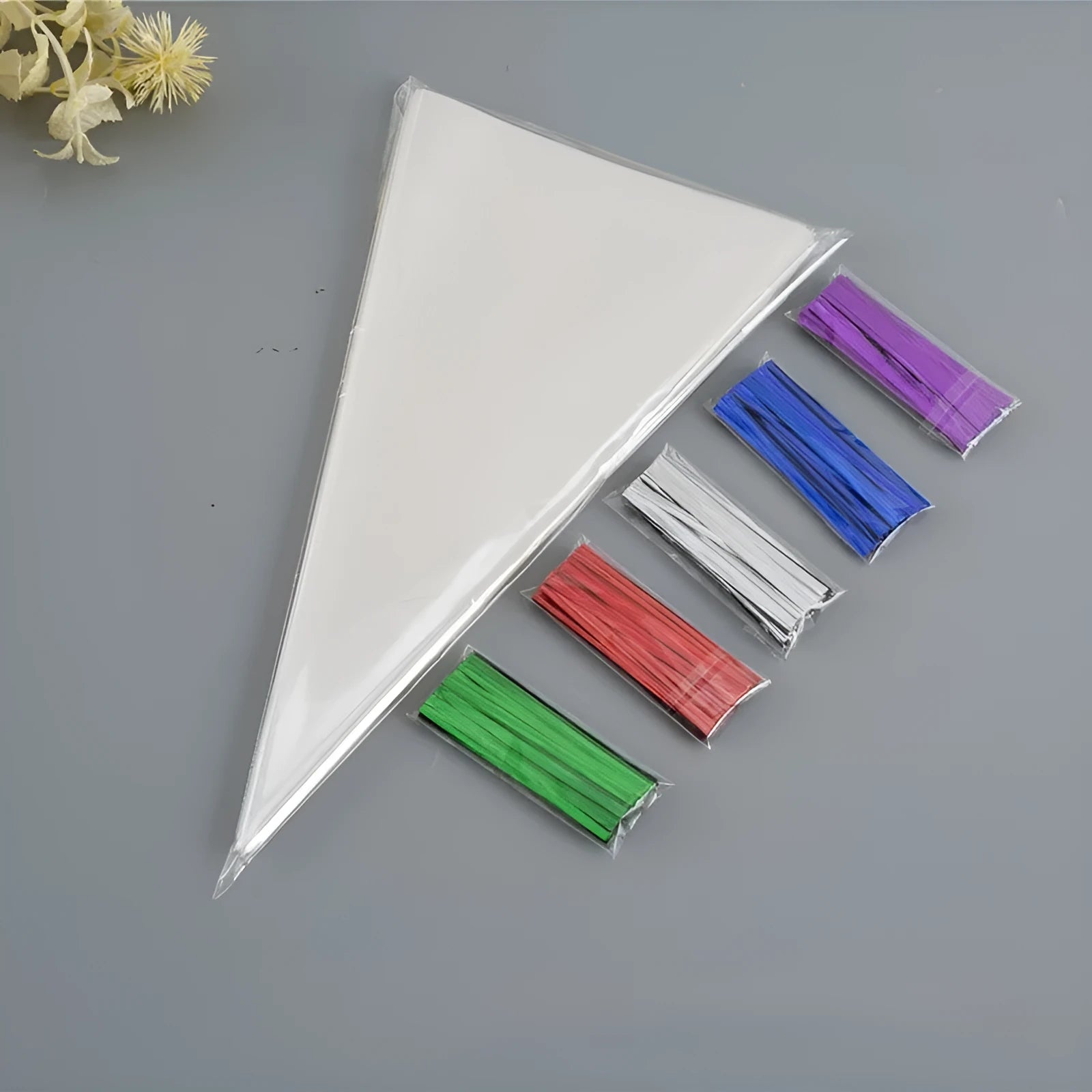 Transparent triangle-shaped plastic OPP bag with a silver tie wire closure, shown in a pack.