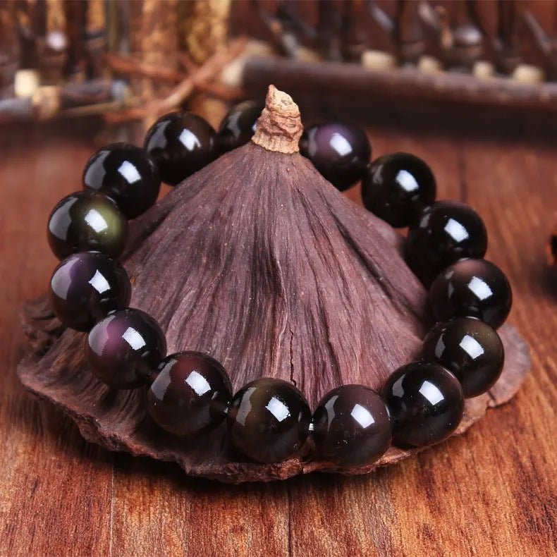 Polished natural crystal Pi Xiu bracelet with geometric beads on a wrist.