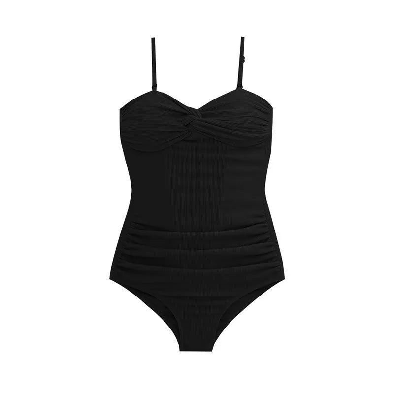 Women's black strapped jumpsuit one-piece swimsuit on a mannequin, side view.