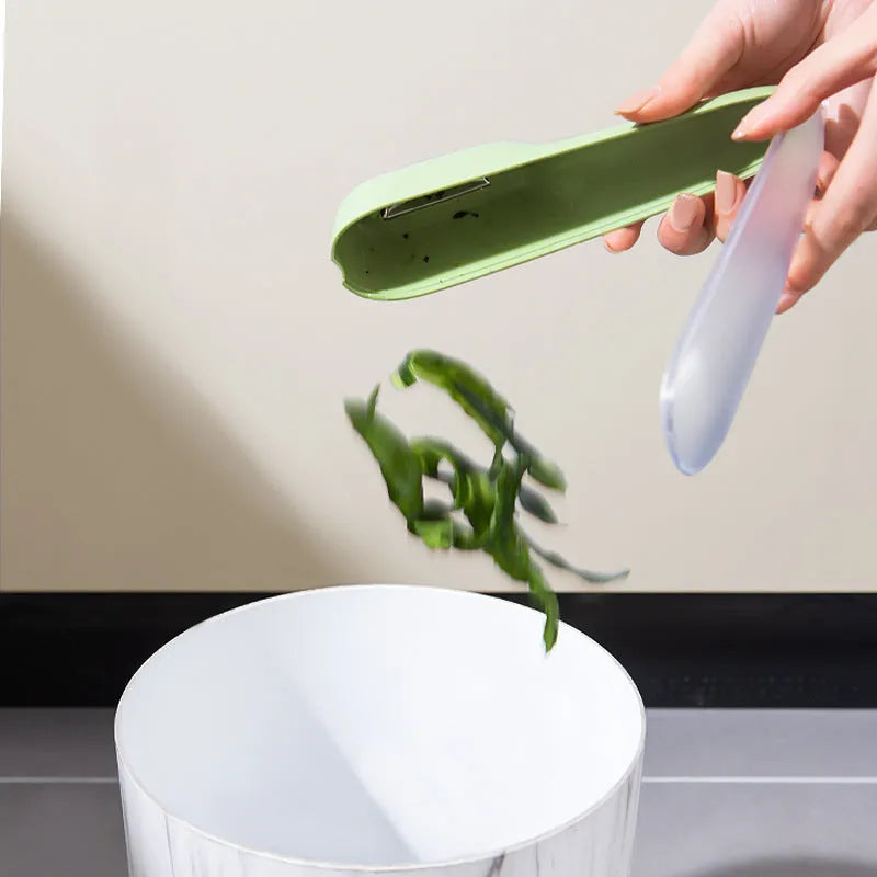 Green kitchen peeler with storage tube, stainless steel blade and hanging hole on handle