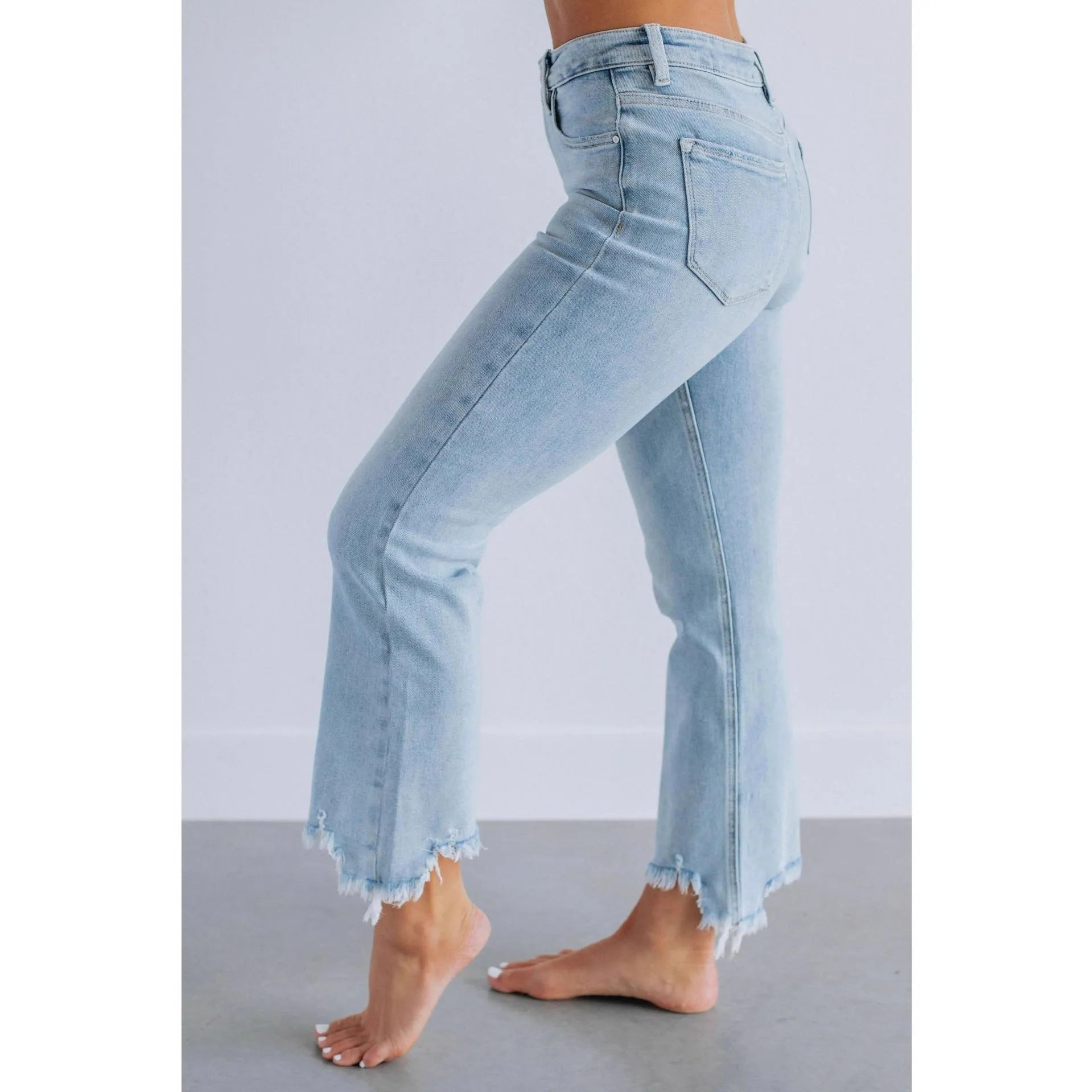 Solid colour women's denim jeans in dark blue and light blue washes, showing hand-worn detail.