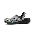 Black women's platform sandals with a hole design and rhinestone details on a lightweight EVA sole.