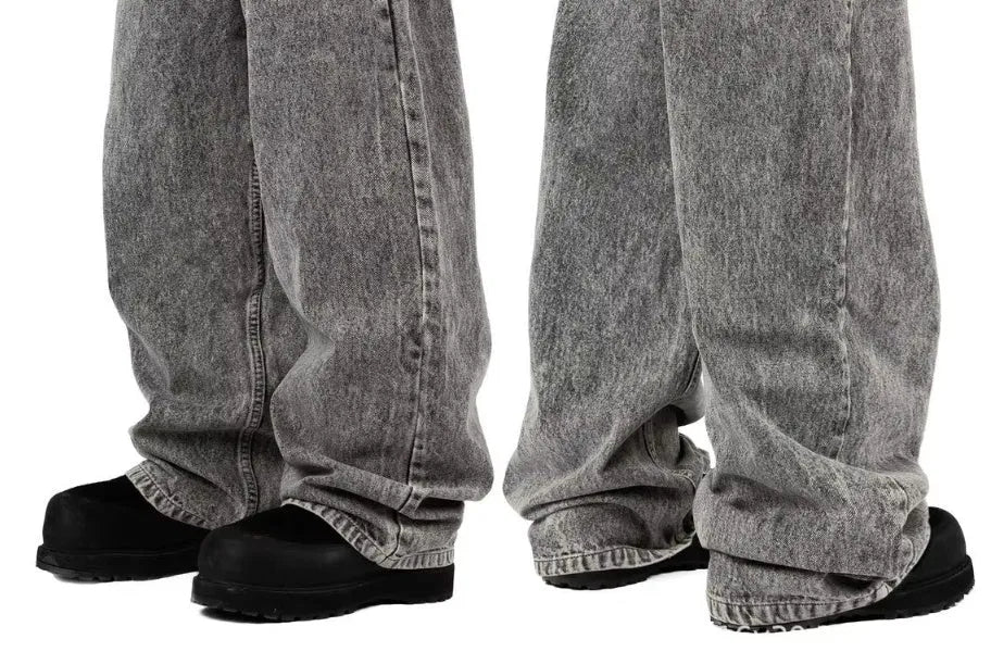 Grey loose-fit straight-leg denim trousers for men and women on a hanger.