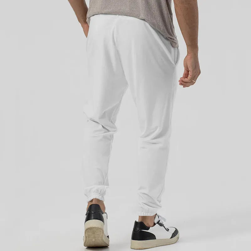 Men's loose tapered casual sweatpants in a grey cotton blend fabric with an elastic waistband.