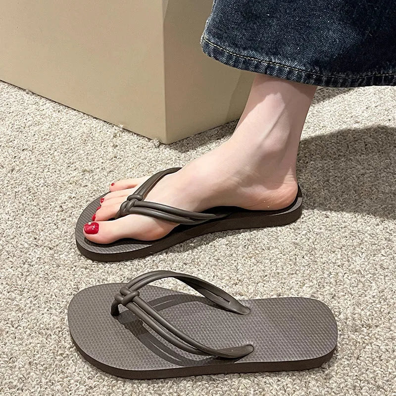 Men's PVC toe covering flip flops in beige on a plain background, showing non-slip sole.