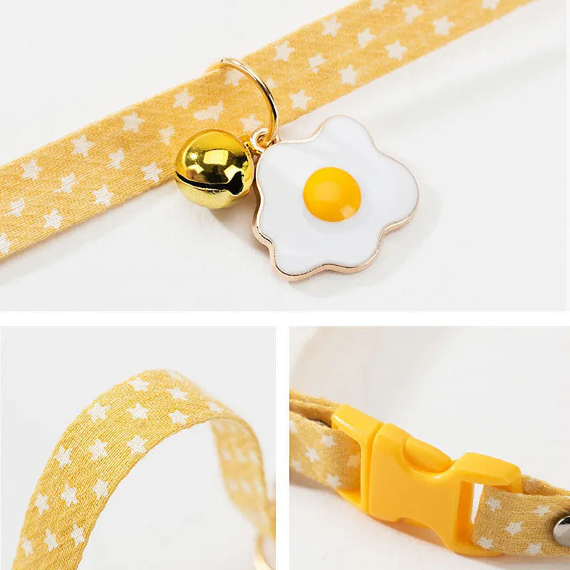 Green adjustable cat collar with a metal bell pendant and a matching bow tie on a white background.