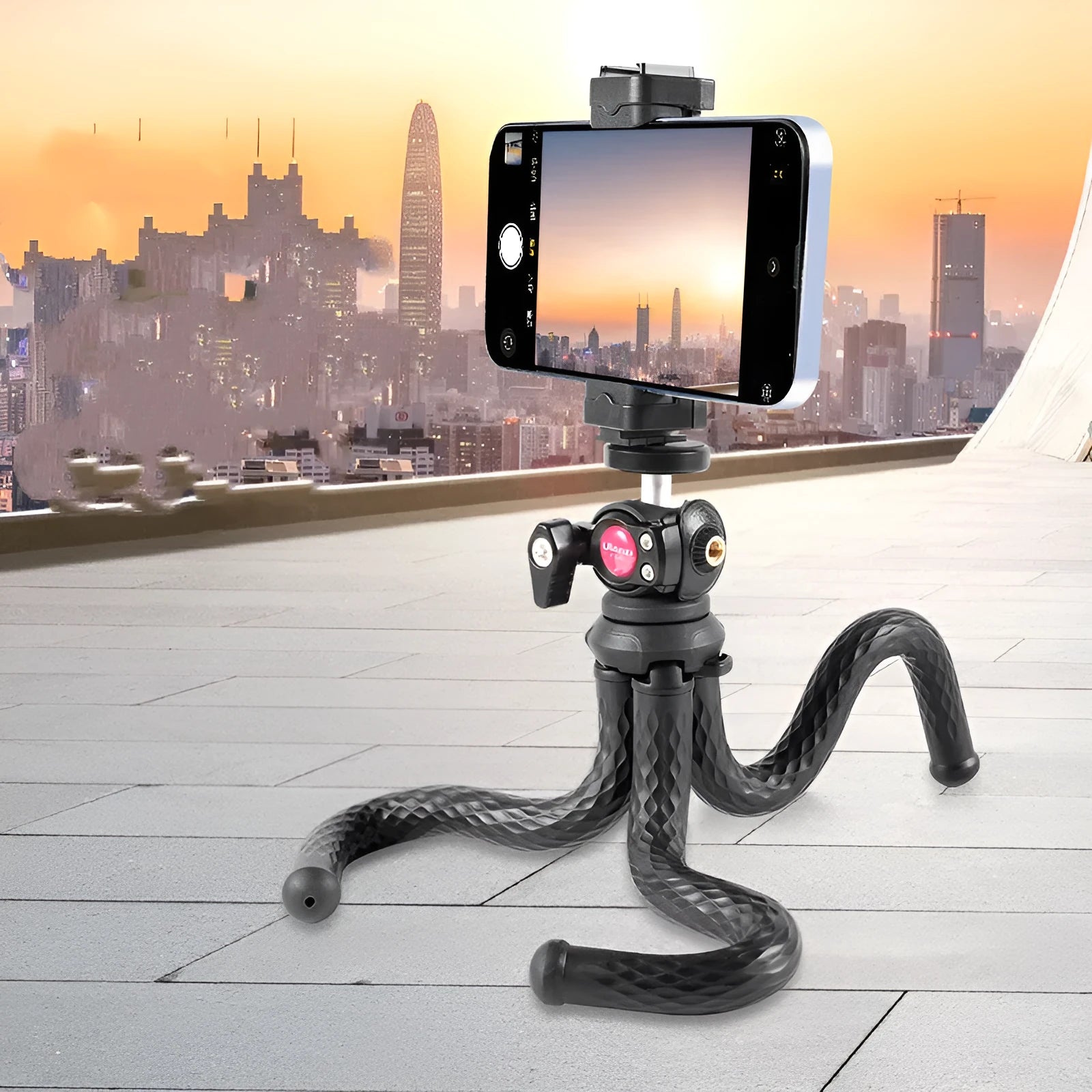 Black octopus tripod with mobile phone clip extended to 360mm length on a table