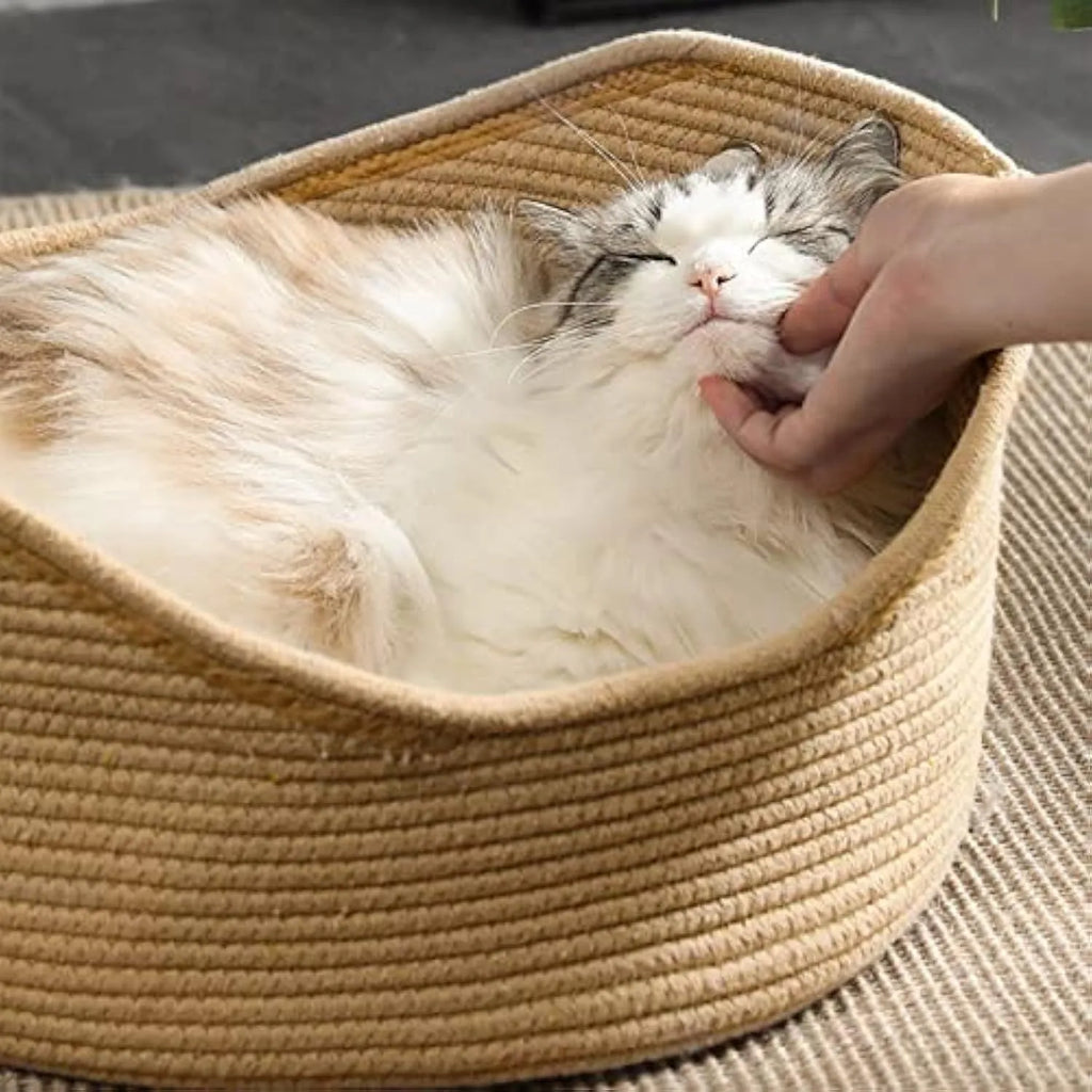 Wicker cat basket bed with a built-in corrugated cardboard scratching panel.