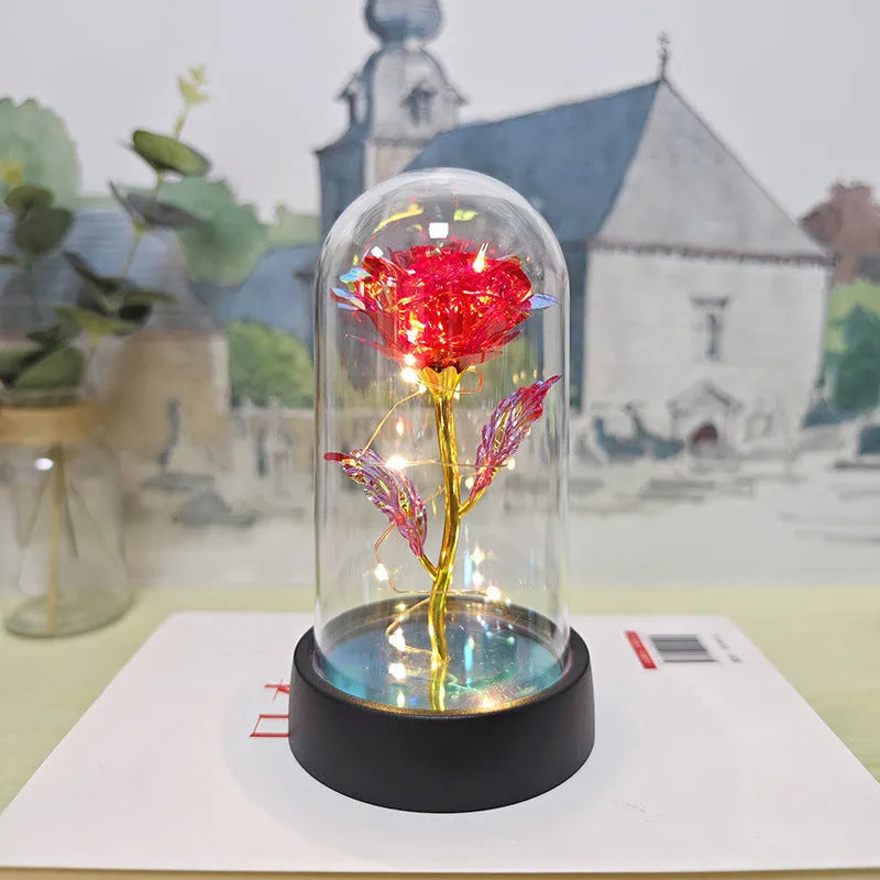 Small plastic night lamp with glass cover and flower decoration on black base