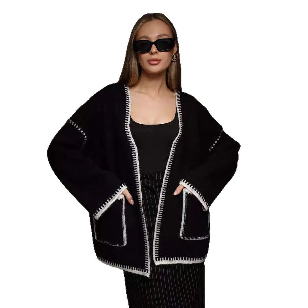 Lace-up front knitted cardigan sweater coat in camel colour, showing loose fit and long sleeves.