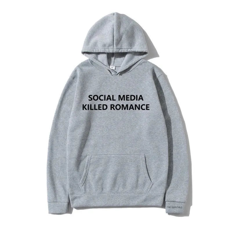 Man wearing a slim fit grey hoodie with a printed white spring letter pattern on the front.