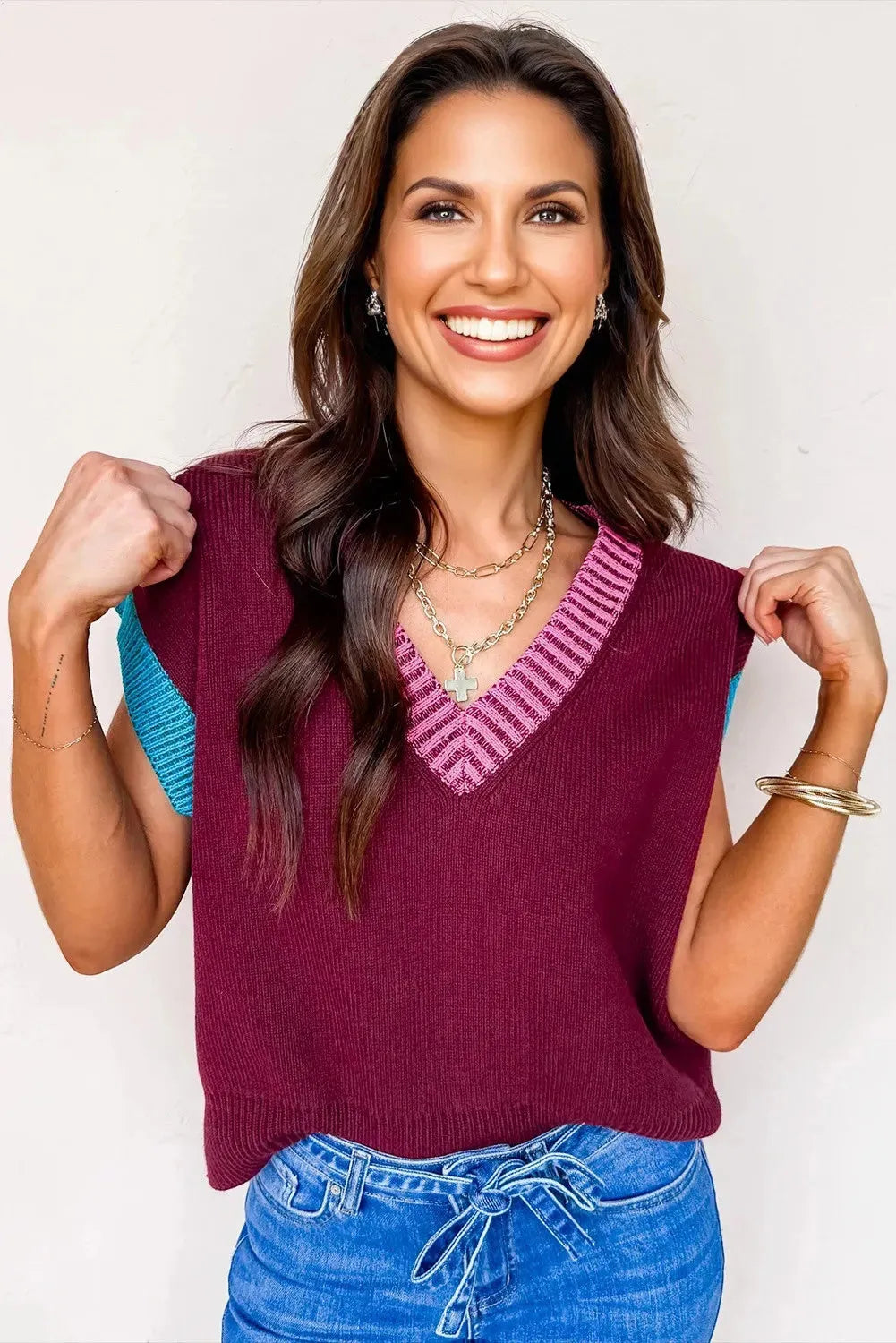 Burgundy women's loose sweater with contrast trim, V neck, and cuffed short sleeves.