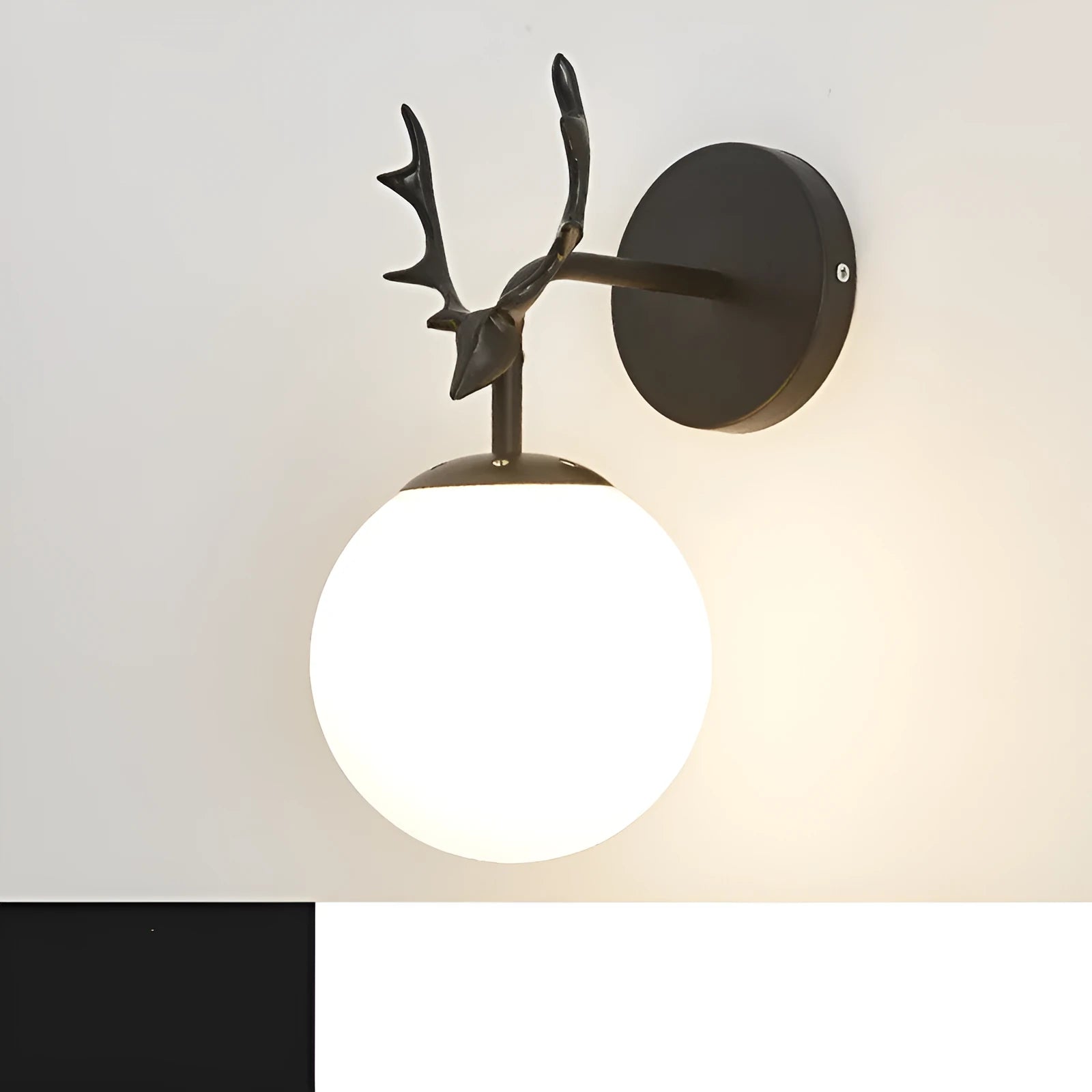 Nordic minimalist round glass wall lamp in golden finish mounted on a wall.