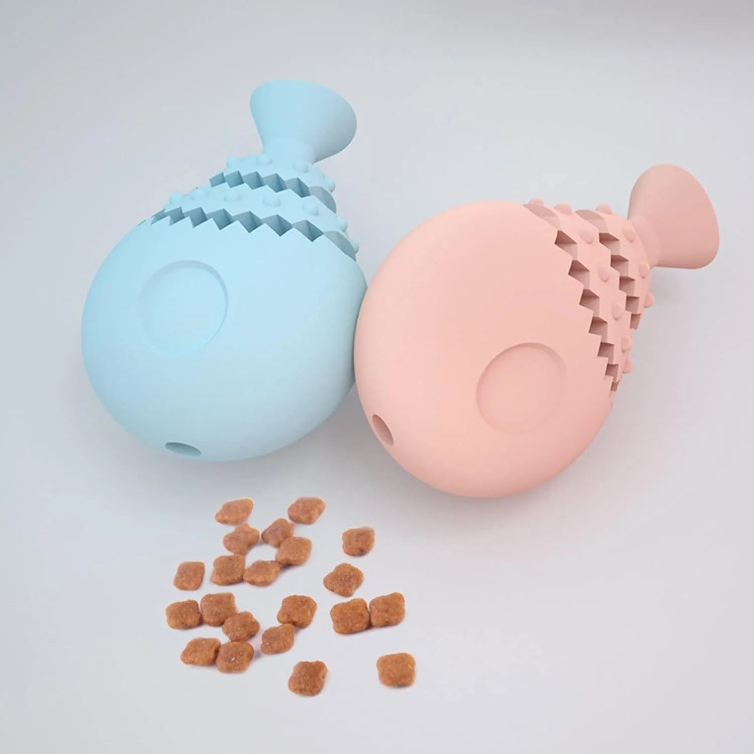 Blue green and pink fish bone shaped silicone dog chew toy with a visible hole in the base