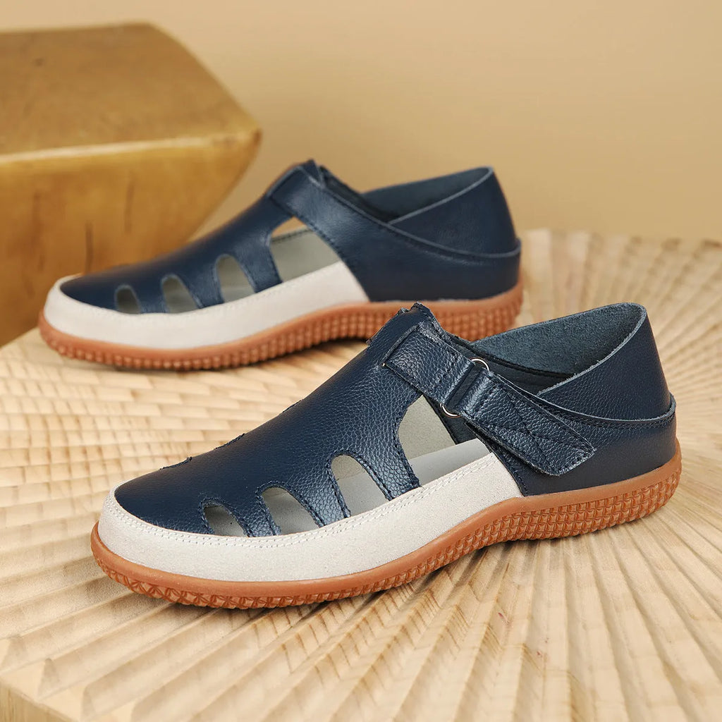 Blue plus size women's flat sandals with hollow-out design and toe cap on a thick rubber sole.