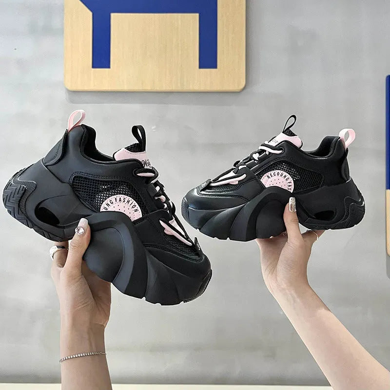 Women's pink sneakers with cross straps and a thick white platform sole.