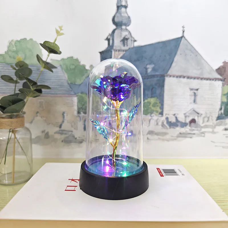 Small plastic night lamp with glass cover and flower decoration on black base