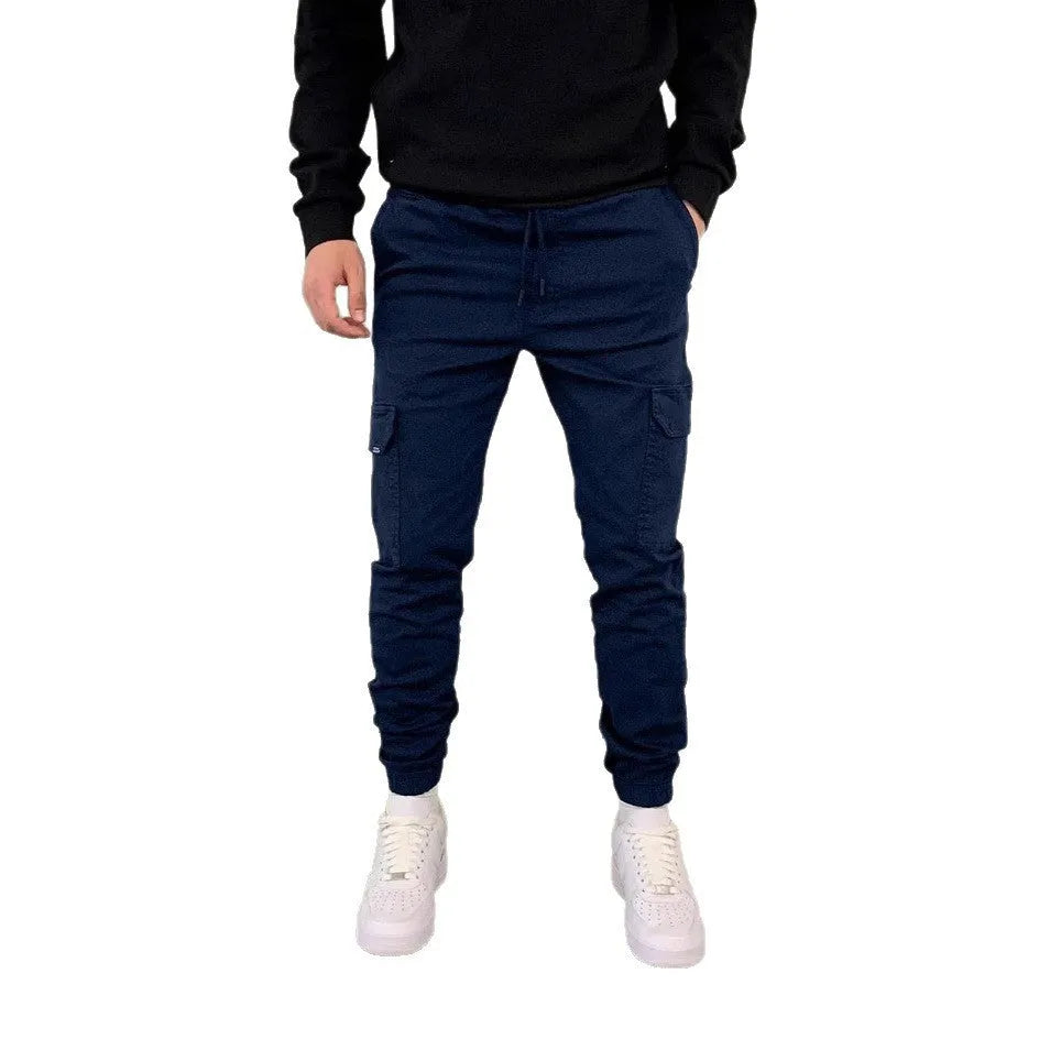 Men's loose polyester trousers with patch pockets and elastic waistband in light blue colour