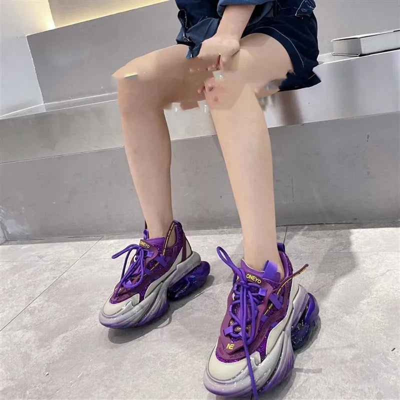 Women's green leather sports shoes with a thick clear jelly sole and white cross-tie laces.