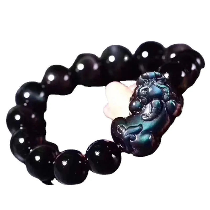 Natural ice colour eye obsidian crystal bracelet on a wrist, showing bead detail.