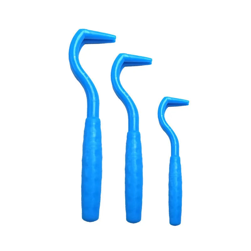 Set of three coloured tick removal hooks for dogs on a white background.