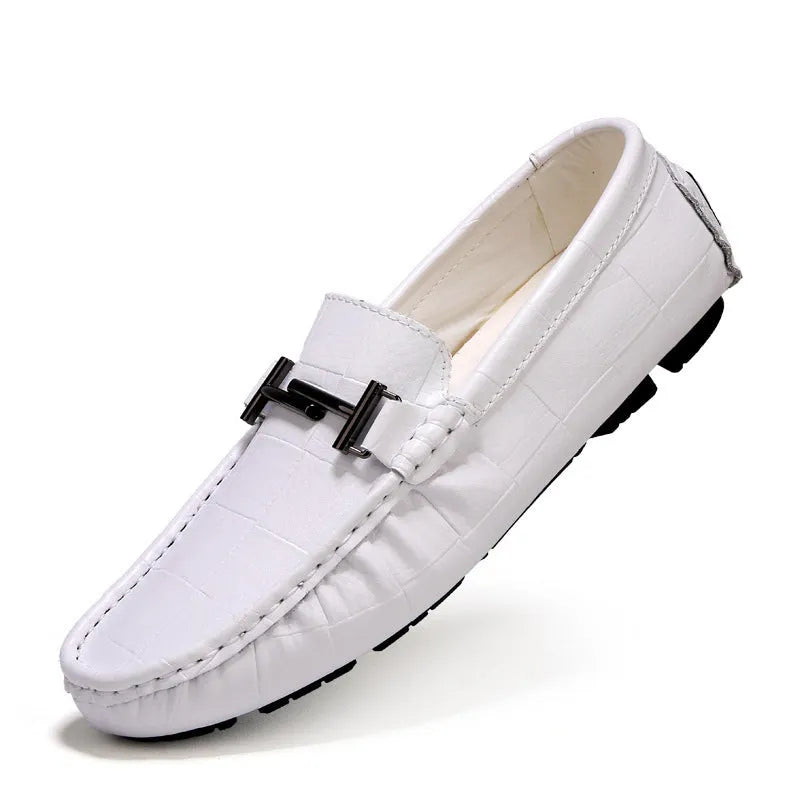 Men's black leather casual shoes with a silver belt buckle and flat rubber sole.
